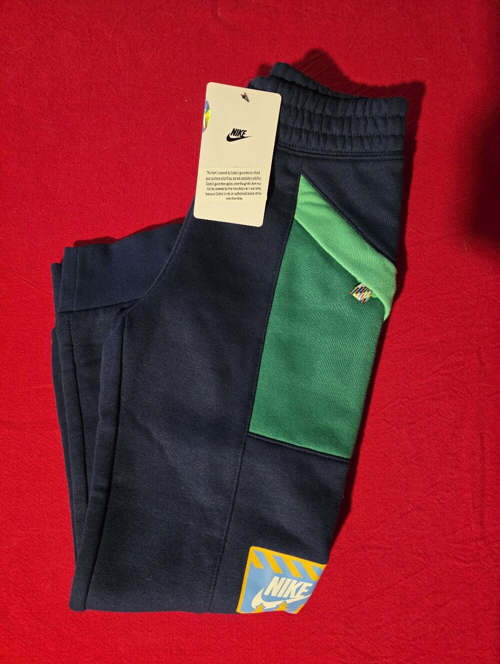 Nike Kids Navy Joggers with Green Pocket Accent